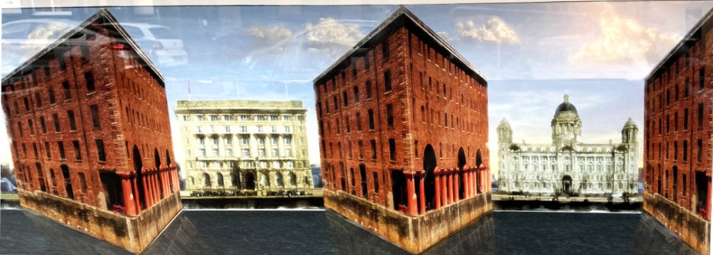 Panoramablick auf das Quirky Quarter mit historischen Backsteinbauten entlang eines Gewässers, die eine einzigartige architektonische Komposition bilden.